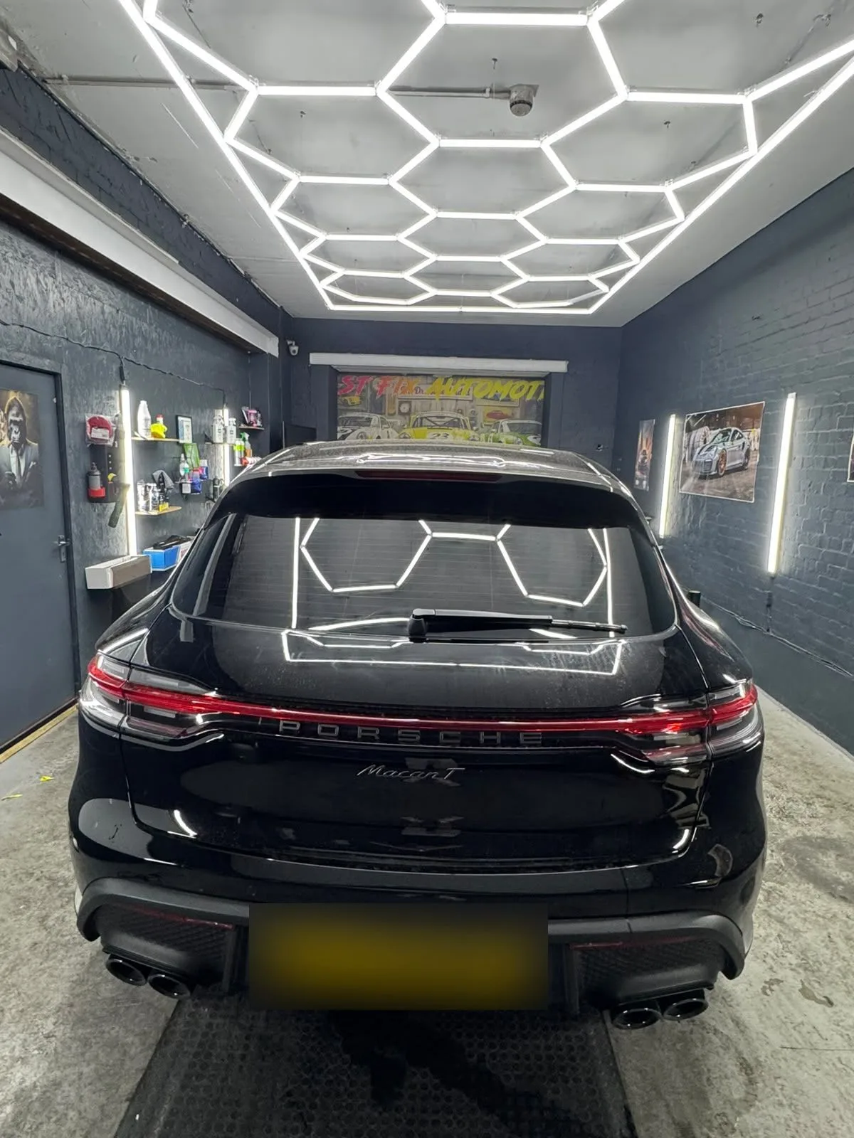 Black SUV with tinted rear glass in the AM TINTS workshop